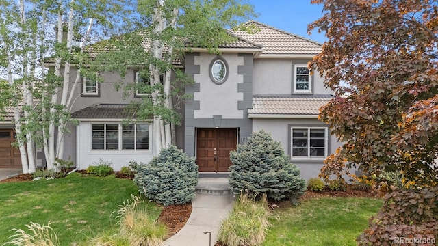 172 S Forest St, Denver, CO 80246 - mediterranean / spanish-style home featuring a tiled roof, stucco siding, a front yard, and a garage
