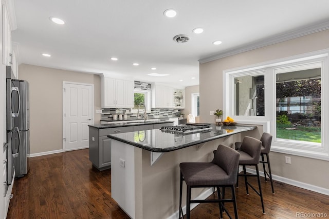172 S Forest St, Denver, CO 80246 - kitchen featuring a center island, a breakfast bar area, tasteful backsplash, white cabinets, and recessed lighting
