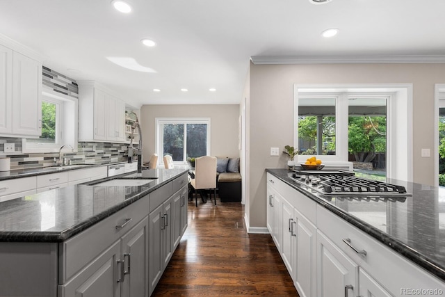 172 S Forest St, Denver, CO 80246 - kitchen with stainless steel gas stovetop, backsplash, recessed lighting, white cabinetry, and dark wood-type flooring