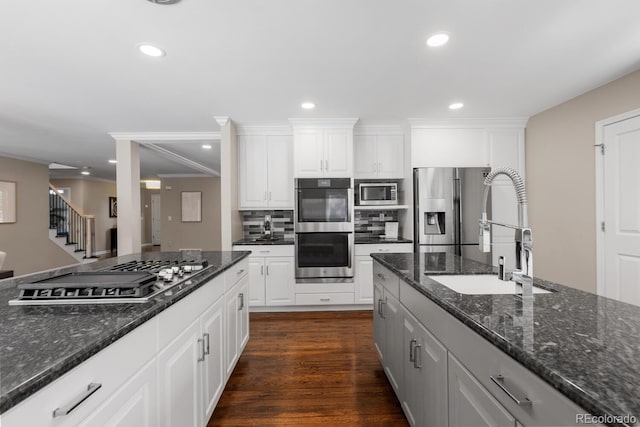 172 S Forest St, Denver, CO 80246 - kitchen with stainless steel appliances, a sink, white cabinets, recessed lighting, and tasteful backsplash