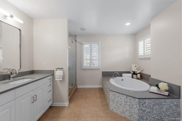 172 S Forest St, Denver, CO 80246 - full bath featuring tile patterned flooring, a stall shower, a garden tub, vanity, and baseboards