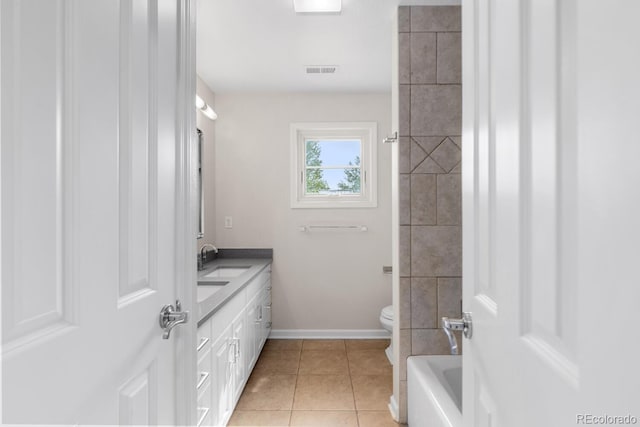 172 S Forest St, Denver, CO 80246 - bathroom featuring toilet, tile patterned floors, double vanity, baseboards, and a tub to relax in