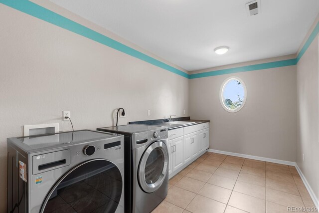 172 S Forest St, Denver, CO 80246 - washroom featuring separate washer and dryer, cabinet space, light tile patterned floors, and baseboards
