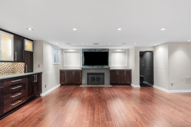172 S Forest St, Denver, CO 80246 - unfurnished living room featuring baseboards, wood finished floors, a large fireplace, and recessed lighting