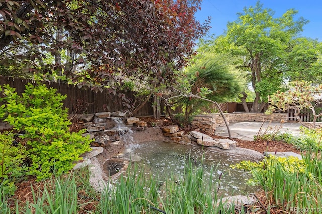 172 S Forest St, Denver, CO 80246 - fenced backyard featuring a patio and a garden pond