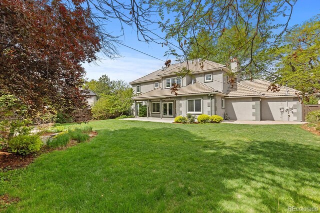 172 S Forest St, Denver, CO 80246 - back of property with a patio area, a garage, a tile roof, stucco siding, and a chimney