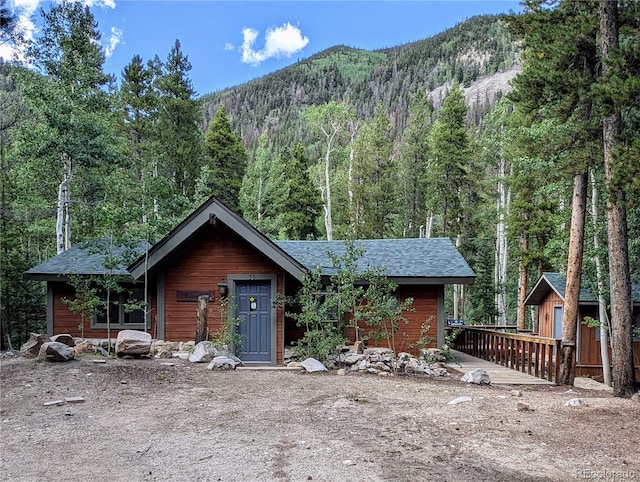 view of front of home with a deck with mountain view