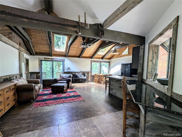 kitchen featuring ceiling fan, black fridge with ice dispenser, wooden ceiling, lofted ceiling with skylight, and a healthy amount of sunlight