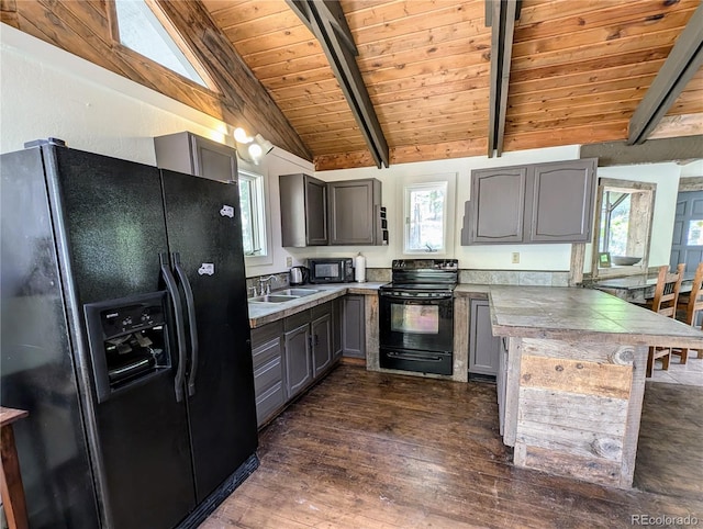 kitchen with vaulted ceiling with beams, sink, dark wood-type flooring, black appliances, and wooden ceiling