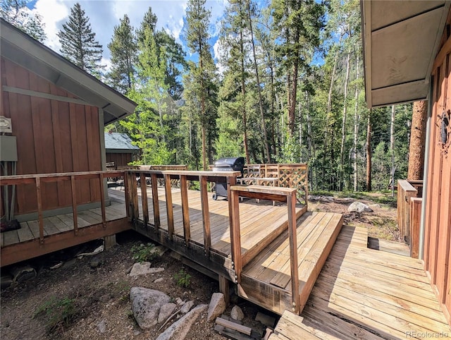 wooden deck with a grill