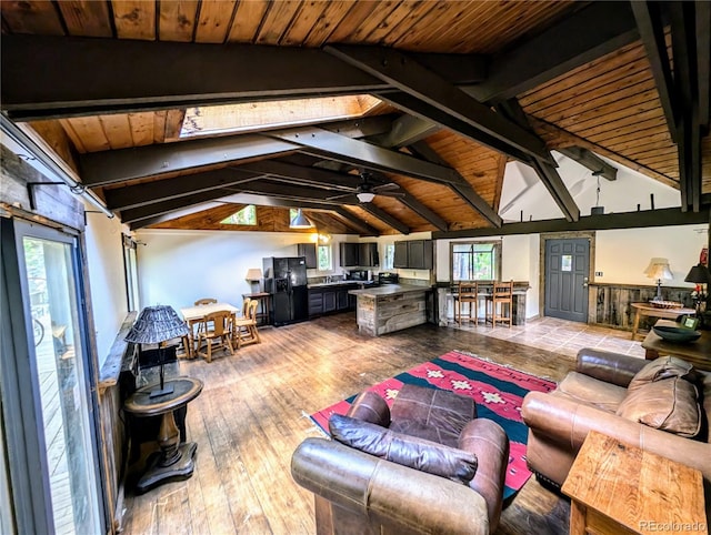 living room featuring ceiling fan, wood ceiling, lofted ceiling with beams, and hardwood / wood-style floors