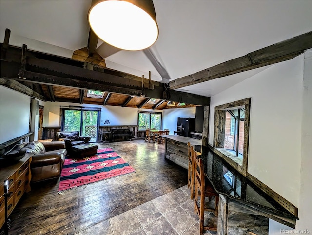 interior space featuring lofted ceiling with beams and hardwood / wood-style flooring