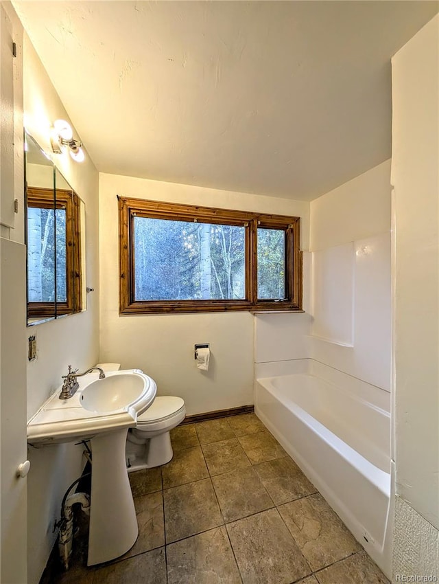 bathroom with a healthy amount of sunlight and toilet