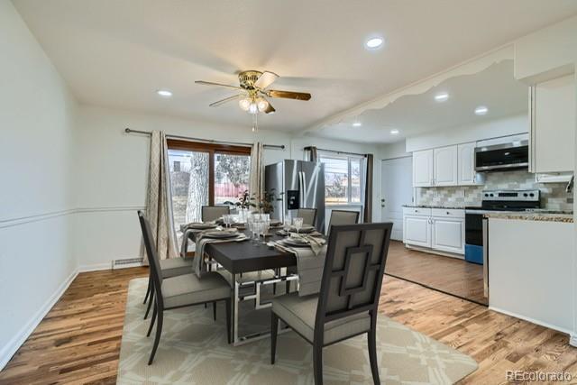 dining room with ceiling fan and light hardwood / wood-style floors