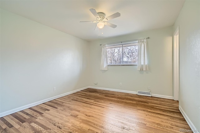 spare room featuring light hardwood / wood-style floors and ceiling fan