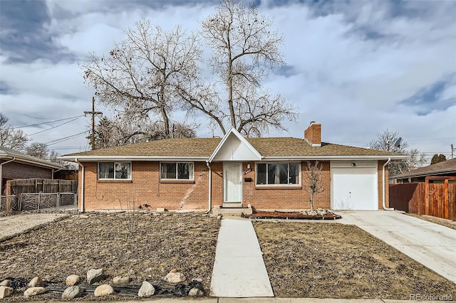 ranch-style house featuring an attached garage, a chimney, fence, and brick siding