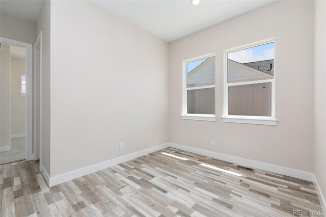 5835 Gianna Dr, Timnath, CO 80547 - spare room featuring wood finished floors, baseboards, plenty of natural light, and recessed lighting
