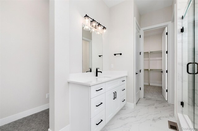 5835 Gianna Dr, Timnath, CO 80547 - bathroom with a spacious closet, a shower stall, vanity, and baseboards
