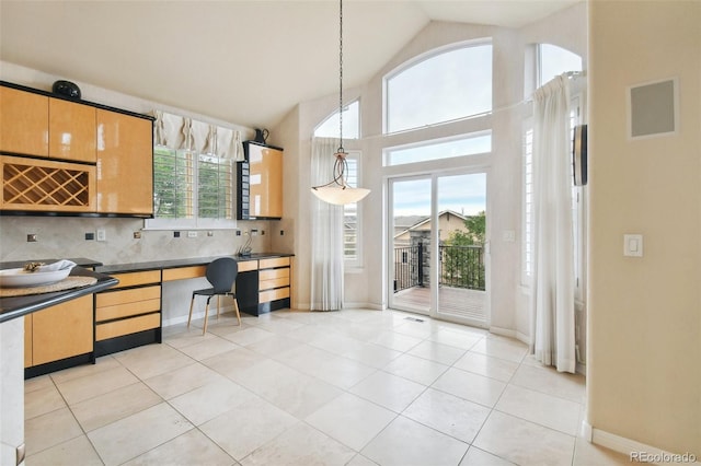 kitchen featuring hanging light fixtures, light tile patterned floors, and plenty of natural light