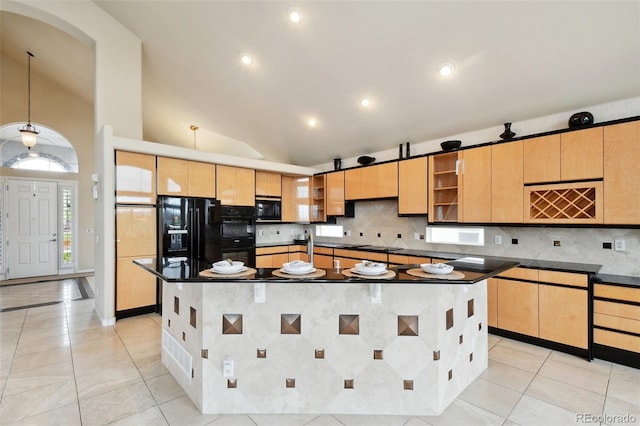 kitchen featuring a center island with sink, hanging light fixtures, black appliances, and light tile patterned flooring