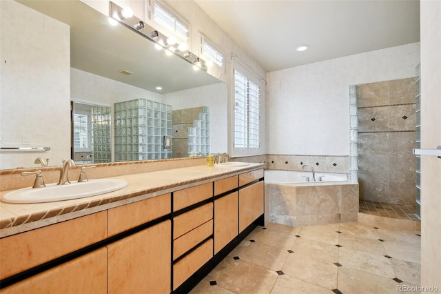 bathroom with tile patterned floors, a healthy amount of sunlight, separate shower and tub, and vanity