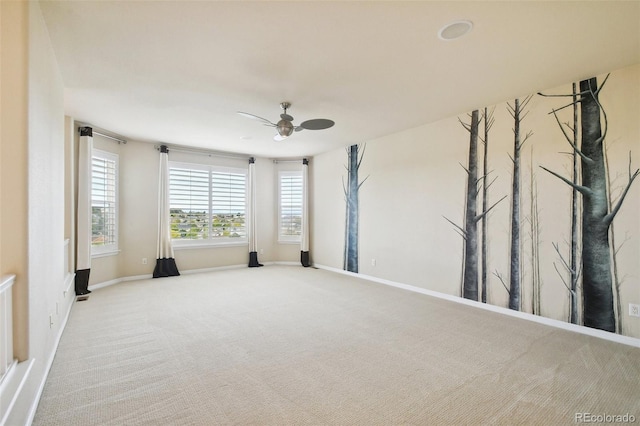 carpeted empty room featuring ceiling fan