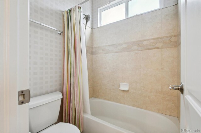 bathroom with toilet and shower / bath combo