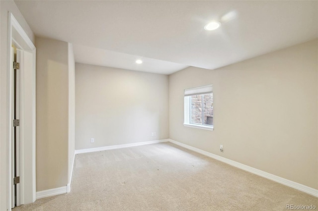 unfurnished room featuring light carpet