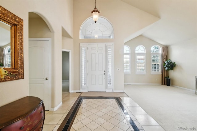 entrance foyer featuring lofted ceiling and light tile patterned flooring