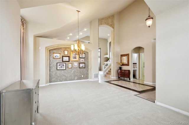 interior space featuring high vaulted ceiling and an inviting chandelier