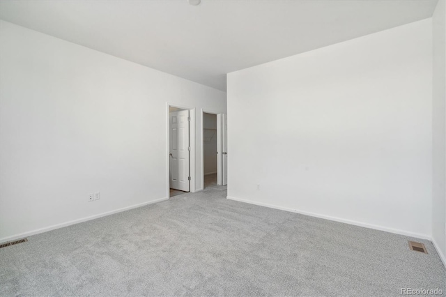 unfurnished room with light colored carpet