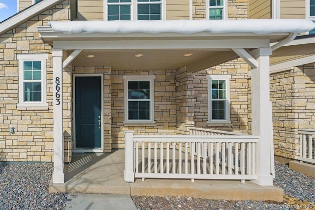 view of exterior entry featuring a porch