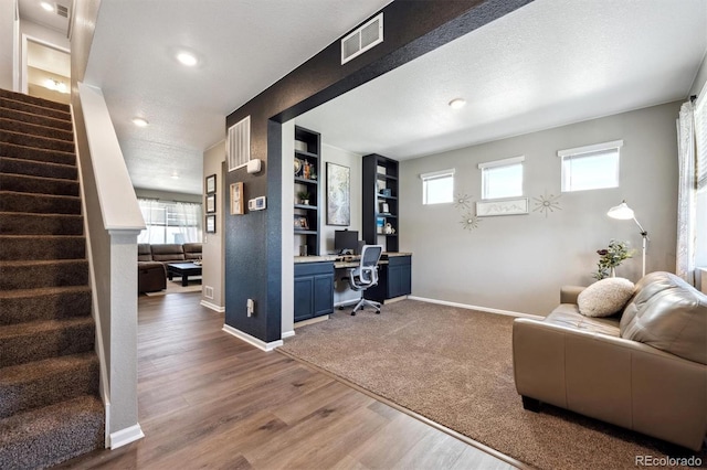 27130 E Maple Ave, Aurora, CO 80018 - office area featuring healthy amount of natural light, baseboards, wood finished floors, recessed lighting, and a textured ceiling