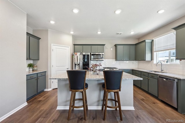 27130 E Maple Ave, Aurora, CO 80018 - kitchen featuring stainless steel appliances, a sink, a center island, tasteful backsplash, and recessed lighting