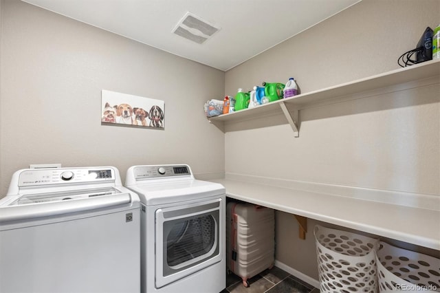 27130 E Maple Ave, Aurora, CO 80018 - laundry room with separate washer and dryer, dark tile patterned flooring, and baseboards
