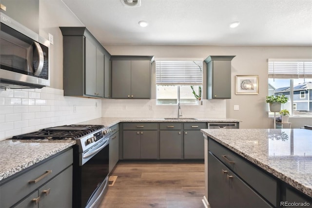 27130 E Maple Ave, Aurora, CO 80018 - kitchen featuring stainless steel appliances, a sink, dark wood-style floors, plenty of natural light, and recessed lighting