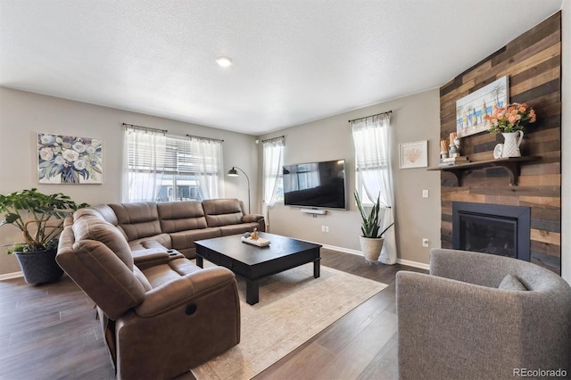 27130 E Maple Ave, Aurora, CO 80018 - living room featuring plenty of natural light, baseboards, dark wood-type flooring, and a textured ceiling