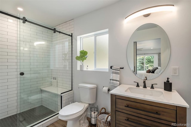 bathroom with walk in shower, vanity, wood-type flooring, a baseboard radiator, and toilet