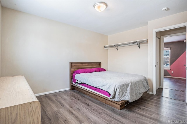 bedroom with dark hardwood / wood-style flooring