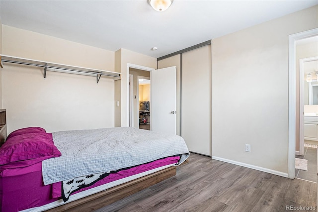 bedroom featuring ensuite bathroom and hardwood / wood-style floors