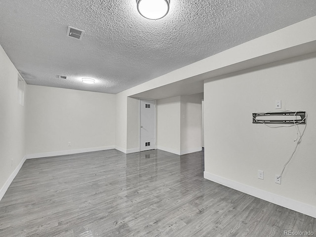 interior space with wood-type flooring and a textured ceiling