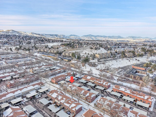 snowy aerial view with a mountain view