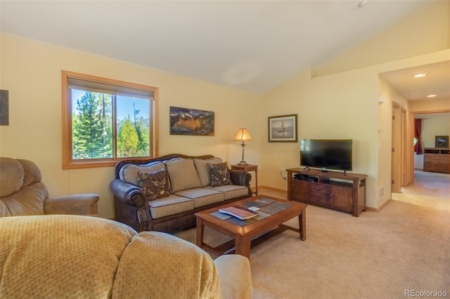 carpeted living room featuring vaulted ceiling