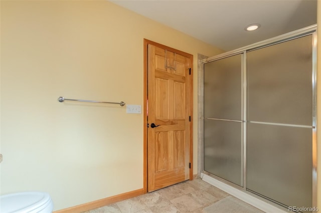 bathroom featuring toilet and walk in shower