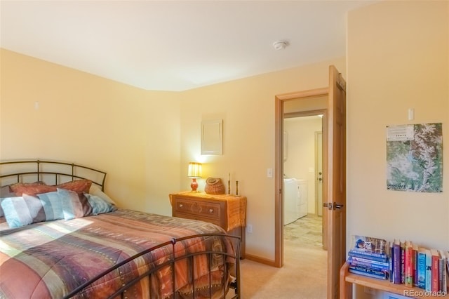 bedroom with washing machine and dryer and light colored carpet