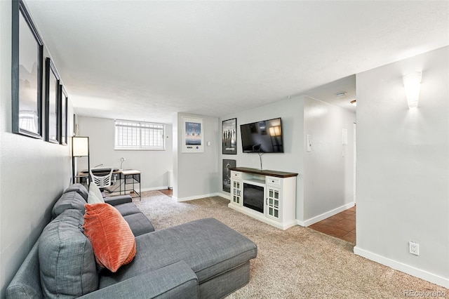 carpeted living room with baseboards