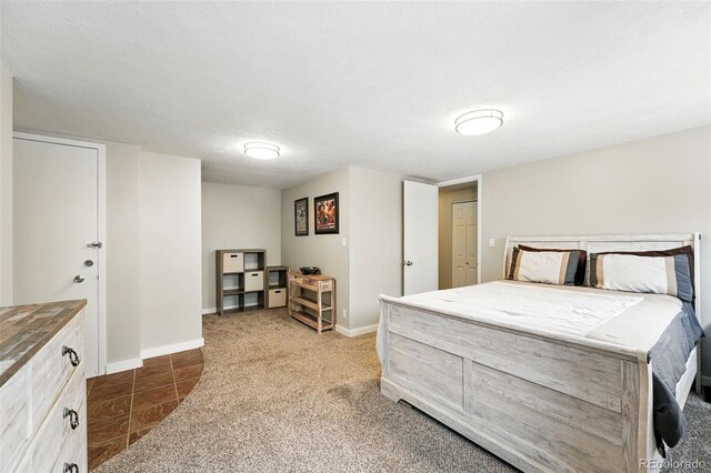 carpeted bedroom featuring baseboards