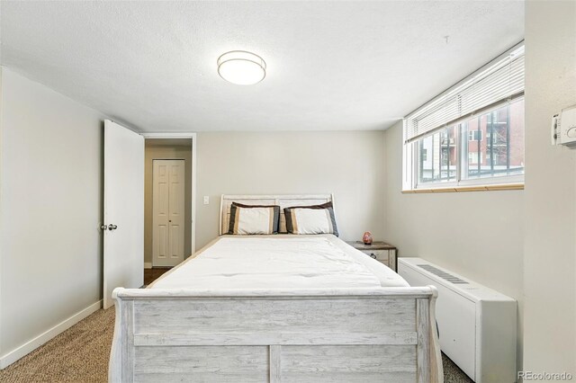 bedroom featuring light colored carpet and baseboards
