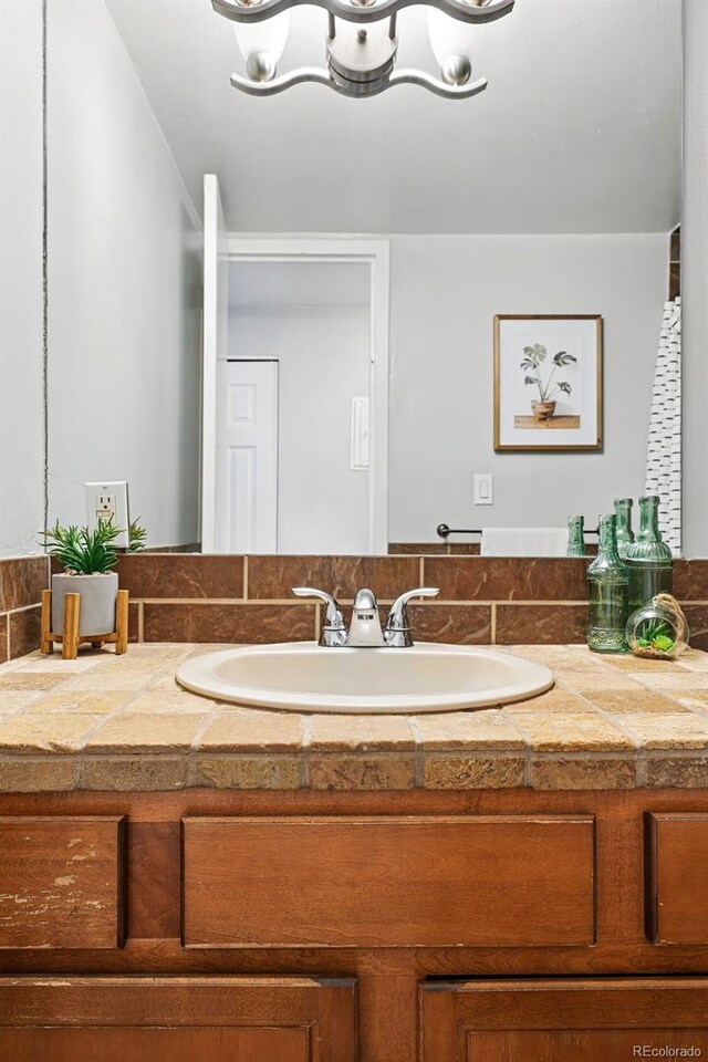 bathroom with vanity and a chandelier