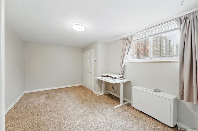 unfurnished bedroom with light colored carpet, baseboards, and a closet
